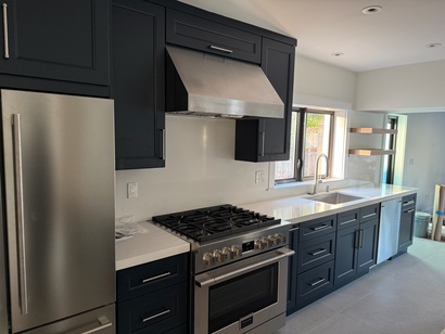 Modern kitchen with exhaust hood and floating shelves
